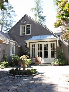 a house that has some plants in front of it