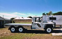 a white truck parked in front of a trailer