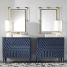 two blue dressers with mirrors and lamps on them