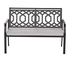 a black metal bench with a cushion on it's armrests and back