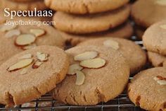 cookies with almonds are cooling on a rack