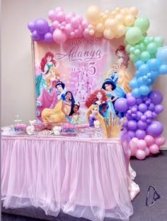 there is a table with balloons and princesses on it