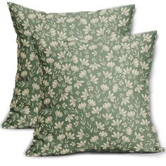 two green pillows with white flowers on them