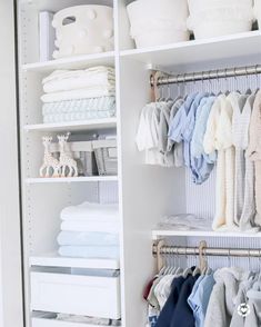 an organized closet filled with baby clothes and blankets, including ones that have been folded