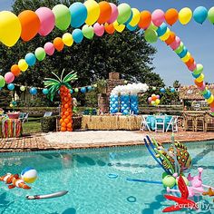 an image of a pool with balloons floating in the air and people on rafts