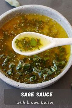 a white bowl filled with soup next to a spoon