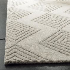 a white rug with diamond shapes on it