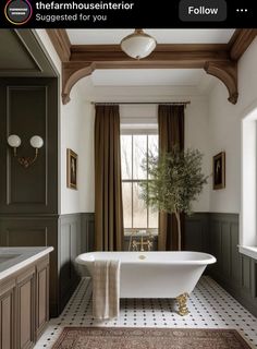 a bathroom with a bathtub, sink and rug on the floor in front of a window