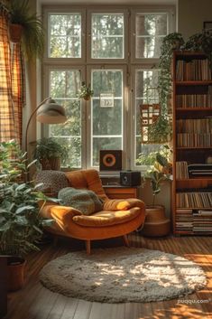 a living room filled with lots of furniture and bookshelves next to a window