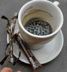 a cup of coffee and some reading glasses