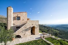 an old stone house on top of a hill