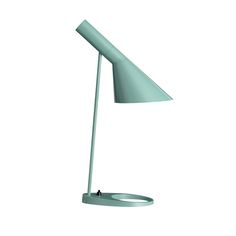 a green table lamp on a white background with the light turned off to show its dim lighting