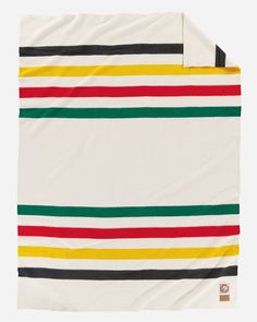 a white blanket with multicolored stripes on it