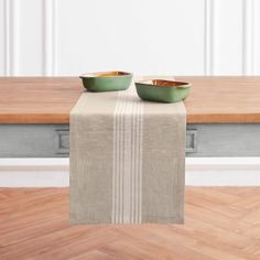 two bowls are sitting on top of a table with a placemat in front of them