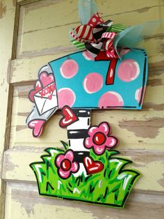 the mailbox is decorated with flowers and hearts