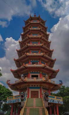 a tall tower with many steps leading up to it's top and the sky in the background