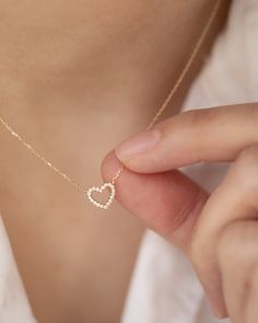 "Add a touch of elegance to your wardrobe with our exquisite 14k gold Tiny Diamond Heart Necklace. This stunning piece features a delicate heart pendant adorned with 18 sparkling diamonds. Perfect for any occasion, the fine gold chain and pendant create a timeless accessory. Treat yourself or a loved one to the allure and sophistication of this brilliant treasure. 14k gold Necklace Length: 16-18\" 8mm / 18 Genuine Diamonds" Elegant Yellow Gold Necklace With Heart Detail, Delicate 14k Gold Necklace For Valentine's Day, Elegant Heart-shaped 14k Gold Necklace, Delicate Yellow Gold Heart Necklace, Elegant Open Heart Necklace In 14k Gold, Delicate 14k Yellow Gold Heart Necklace, Elegant 14k Gold Heart Necklace With Delicate Chain, Delicate 14k Gold Heart Necklace For Wedding, Delicate Heart Necklace For Anniversary