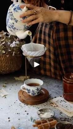 a woman pouring tea into a cup