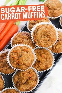 carrot muffins in paper cups on a tray with carrots and celery