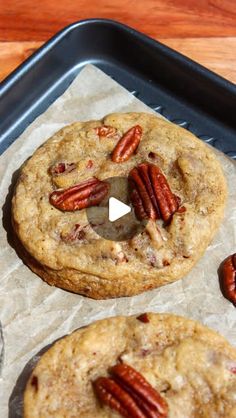 two pecan cookies sitting on top of a pan