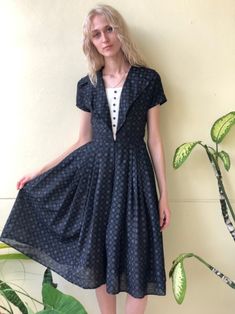 "Super sweet printed black cotton dress with full skirt. Bust: 34\" Waist: 25\" Hips: free Length: 44\" Circa: 1950's Condition: Good vintage condition. A bit of wear to the underarms where the print has somehow worn off a bit, nothing major. Several mends. The hem has come out of it's last fold but is still finished and looks fine. A hint of yellowing to the tuxedo part. Priced accordingly. For fun stuff---closetcasevintage instagram.com/closetcasevintage Please read our store policies." Retro Black Fit And Flare Dress, Black Short Sleeve Dress For Vintage Fashion, Black Vintage Fit And Flare Dress, Black Retro Dress For Daywear, Black Retro Daywear Dress, Black Vintage Dresses For Vintage Fashion, Vintage Black Dress For Daywear, Black Vintage Dress For Daywear, Vintage Black Midi Length Dress