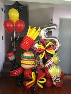 the balloon sculpture is made to look like mcdonald's fries and hotdogs