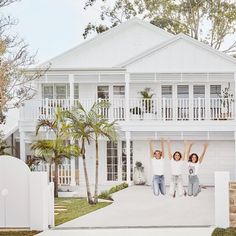 a white house with palm trees in front of it