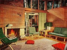 a living room filled with furniture and a fire place in the middle of a wooden floor