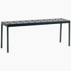 a black table with four holes on the top and one hole at the bottom, in front of a white background