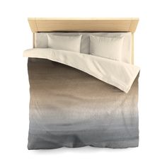 an image of a bed with two pillows and sheets on it's headboard