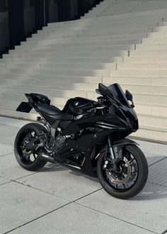 a black motorcycle parked in front of some steps