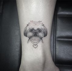 a small dog with a heart tattoo on the ankle is shown in black and white