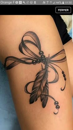 a woman's thigh with a tattoo on it and an arrow in the middle