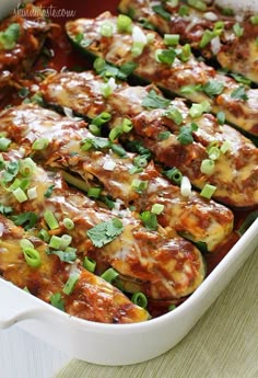 an enchilada dish in a white casserole dish on a table