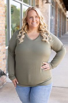 Add sophistication to your everyday attire with the Larissa Long Sleeve Top in olive. This essential V-neck top blends timeless style with modern comfort, making it perfect for any occasion. Crafted from a soft mix of 95% rayon and 5% spandex, it offers a snug yet flexible fit that moves with you. Whether you're dressing up for a night out or keeping it casual for a day in, this top ensures you stay cozy with its long sleeves and relaxed fit. Fabric Composition: Premium blend of 95% rayon and 5% spandex for supreme comfort.Fit: Designed to run true to size for a perfect fit every time.Model Sizing: Tiffanee is effortlessly stylish in a size small, while Lexi looks stunning in 1XL. Versatile Green V-neck Top, Olive V-neck Tops For Spring, Casual Olive V-neck Top, Stay Cozy, Beautiful Eyes, Top Trends, V Neck Tops, Timeless Style, Long Sleeve Top