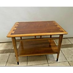 a wooden table sitting on top of a tiled floor