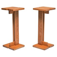 two wooden pedestals are shown against a white background