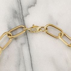 This Italian handcrafted chain link necklace is completely composed of 14K solid gold and is uniquely made with a semi-hollow interior for comfortable everyday wear that will not dent. NOTE: This item is available in longer or shorter length options. Kindly email us for pricing and details. Total Length: available in your choice of 14, 16, 18, 20, 22, 24, 26 or 30 inches Total Gram Weight: 18" length comes out to approximately 33.8 grams of 14K solid gold Link Dimensions: approximately 14mm (W) Yellow Gold Chunky Chain Jewelry With Oval Links, Classic Oval Gold Chain Jewelry, Classic Oval Gold Plated Chain Necklace, Gold-tone Oval Link Paperclip Bracelet With Lobster Clasp, Gold-tone Oval Link Paperclip Chain Jewelry, Luxury Gold Plated Chain Necklace, Gold-tone Jewelry With Oval Link Paperclip Chain, Gold Plated Oval Gold Chain Jewelry, Gold Plated Oval Chain Necklace