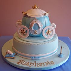 a blue and white cake with a carriage on top