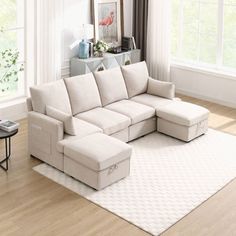 a living room with a sectional couch and coffee table on the floor in front of a large window