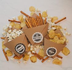 some snacks are laying out on top of the popcorn and crackers that have been placed next to each other