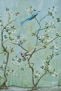 two birds sitting on top of a tree with white flowers in the foreground and a blue bird flying over it