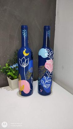 two blue vases with flowers painted on them