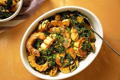 two bowls filled with food on top of a table