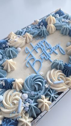 a blue and white birthday cake with frosting