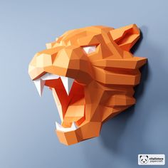 a paper sculpture of a tiger's head with its mouth open and sharp teeth