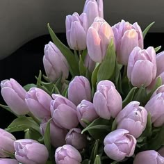 a bunch of pink tulips are in a vase