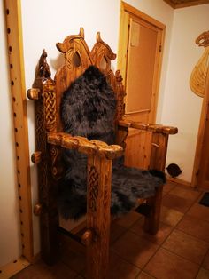 a chair made out of wood with a black fur on it's back and legs