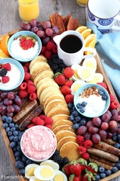 a platter filled with fruit, crackers and yogurt