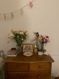 a wooden dresser topped with lots of flowers